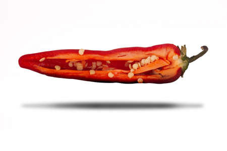 Red hot chilli pepper sliced in half close up isolated on a white background with shadowの写真素材