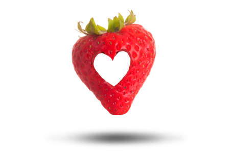 Love heart cut through a red strawberry isolated on a white background. Love fresh fruit conceptの写真素材