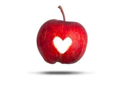 Love heart cut through a red apple isolated on a white background. Love fresh fruit conceptの写真素材