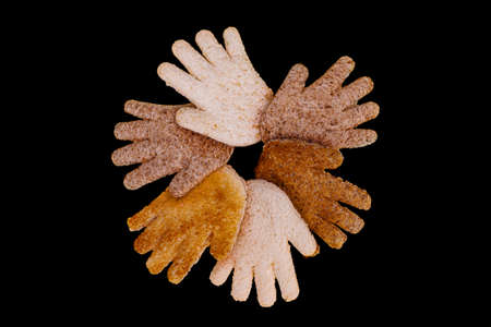 Multicultural hands together in a circle made from toasted bread on a black backgroundの写真素材