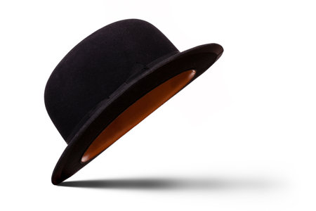 Black bowler hat tilted to see underneath with shadow isolated on white backgroundの写真素材