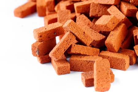 Pile of house bricks close up with text space on a white backgroundの写真素材