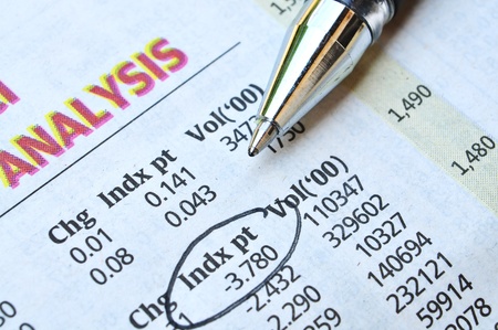 economic analysis on newspaper and pointing numbers by ballpenの写真素材