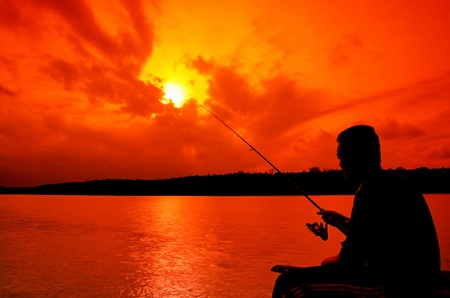 Silhouette man fishingの写真素材