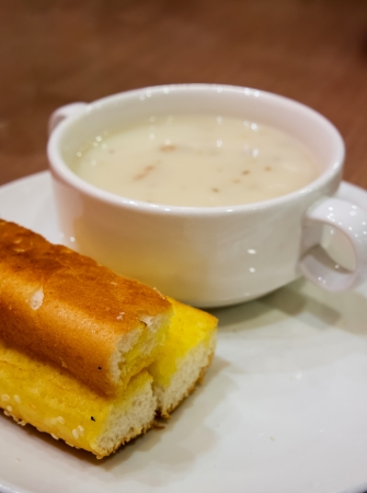 Bowl of cream of mushroom soup with breadの写真素材