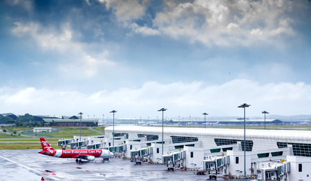 MALAYSIA-18 JULY 2016 - AirAsia Terminal in Kuala Lumpur Airport and storm clouds landscape. AirAsia is one of famous low cost airplanes at new Kuala Lumpur International Airport 2 terminal (KLIA 2).のeditorial素材