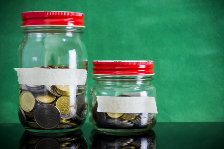 Gold and silver coin close up in jar. Copy space concept for saving fund, financial, banking, investment, money or other your content. Malaysia coins.の写真素材