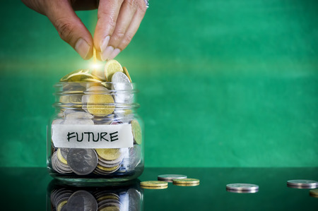 Preparation for future and financial concept. Coins in glass jar with FUTURE label. Malaysia coins.の写真素材