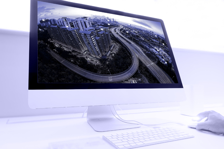 World wide connection and communication concept. Blue tone cityscape connection concept blending with computer desktop.の写真素材