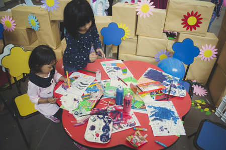 KUALA LUMPUR, MALAYSIA - NOVEMBER 5, 2016 : Group of cute little preschool kids drawing with colorful pencils.のeditorial素材