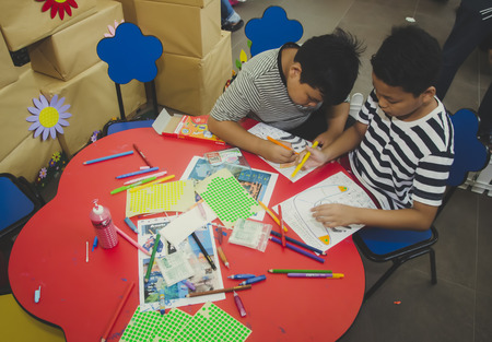 KUALA LUMPUR, MALAYSIA - NOVEMBER 5, 2016 : Group of cute little preschool kids drawing with colorful pencils.のeditorial素材