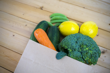 Healthy and nutrition eating. Fresh vegetables in paper bags. Vignette effect and selective focus.の写真素材