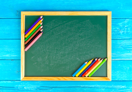 Close up arrangement of pencil color and chalk board on blue background. Preschool, education, back to school and copy-space concept or other your content.の写真素材