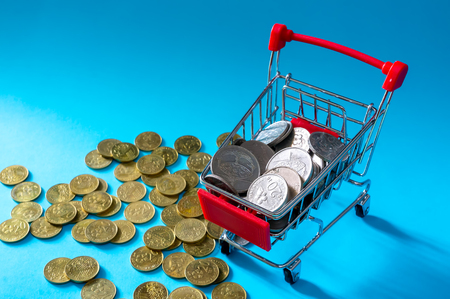 Shopping and e-commerce concept.Saving Money Concept. Shopping trolley or cart with coin.の写真素材