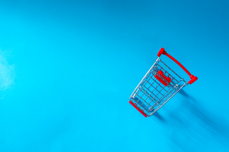 Top View of shopping trolley on blue background with  copy space.の写真素材