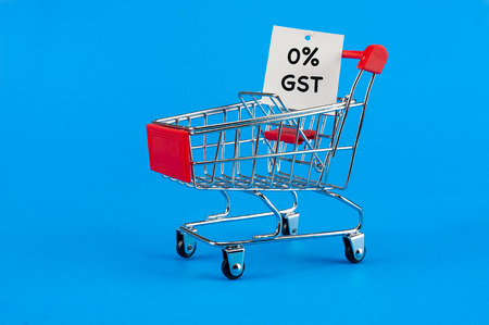 GST and TAX concept. Shopping cart with a card written a 0% GST.の写真素材
