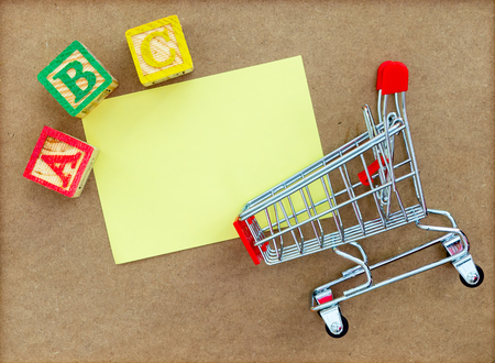 Alphabet blocks with trolley and copy-space. Stationary shopping and back to school concept. Pre-school concept.の写真素材