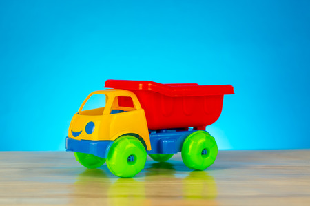 Colorful toy truck isolated on blue backgroundの写真素材