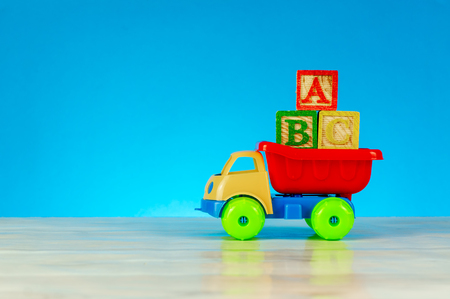 Colorful toy truck with alphabet blocks arrangement of ABC. Pre school, back to school concept.の写真素材