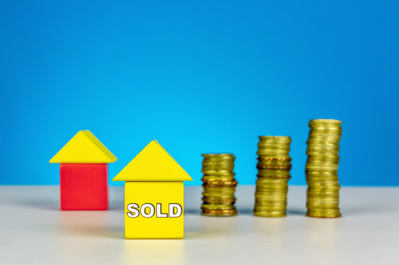 Property sold. Wood cube with stacking coin. Properties sold, investment, rental concept or other your content.の写真素材
