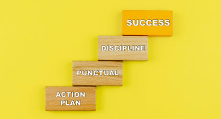 Successful step. Wood block stacking as step stair on yellow background, Goal achievement goal concept for growth success process.の写真素材