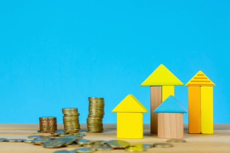 House Wooden Block with stacking coins. Investment or saving for real estate. Investment, saving and development concept or other your content.の写真素材