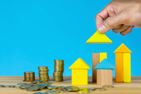 Investment or saving for real estate. Hand holding wooden house. Investment, saving and development concept or other your content.の写真素材