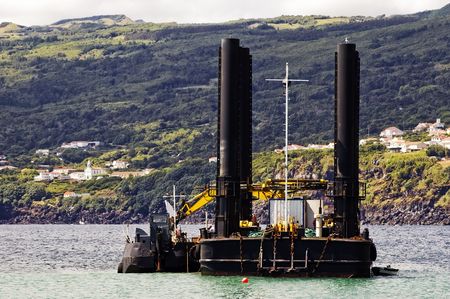 Dredger and barge working near the shore