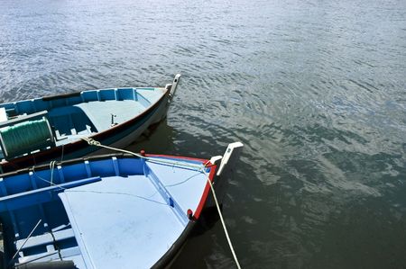 Couple of small fishing rowboats mooredの写真素材