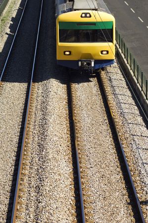 Oncoming suburban train on railway tracks.の写真素材