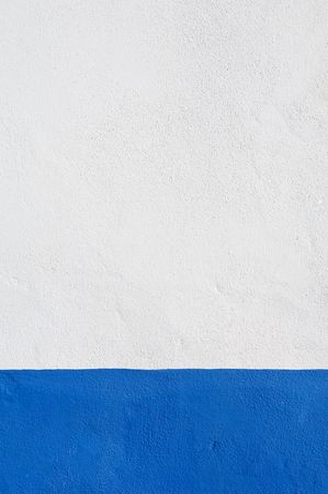 Detail of white wall with a nice deep blue baseboard の写真素材