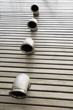 Pipes in a stainless steel metal floor の写真素材