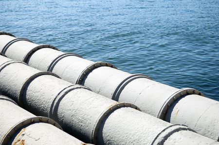 A closeup of large sewage pipes, leading out to the sea.の写真素材