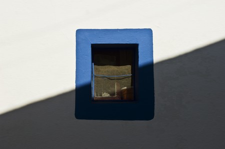 Small window painted with a blue border の写真素材