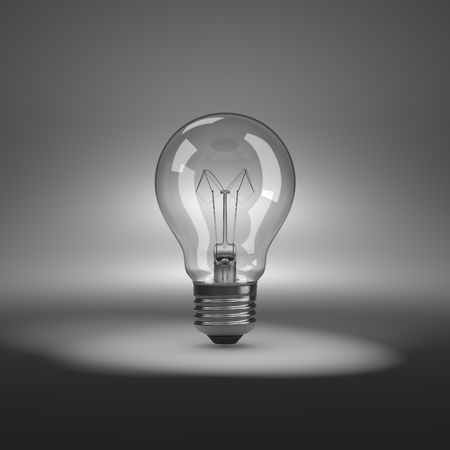 One Single Light Bulb under Spotlightの写真素材