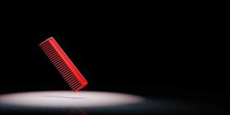 Red Comb Spotlighted on Black Background with Copy Space 3D Illustrationの写真素材