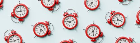 Red Alarm Clocks on Light Blue Backgroundの写真素材