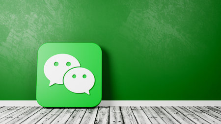 Wechat App Icon on Wooden Floor Against Wallのeditorial素材