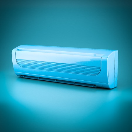 Image of modern air conditioner on a blue backgroundの写真素材
