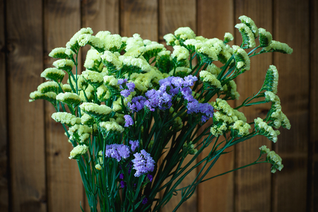 Beautiful flowers on a background of wooden boardsの写真素材