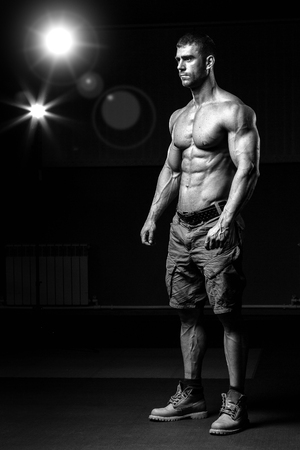 Male bodybuilder, fitness model trains in the gym. Black and whiteの写真素材