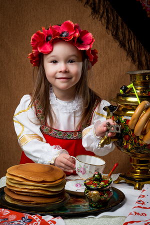 Pancake week. Spring holiday. Portrait of a girl in national costume.の写真素材