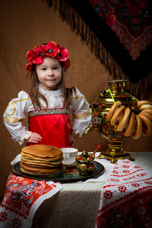 Pancake week. Spring holiday. Portrait of a girl in national costume.の写真素材
