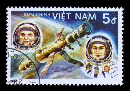 VIETNAM - CIRCA 1986. A stamp printed in Vietnam shows vietnam cosmonaut Pham Tuan and soviet cosmonaut Viktor Gorbatko, 1986の写真素材