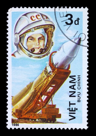 VIETNAM - CIRCA 1986: A stamp printed in the Vietnam shows women cosmonaut and rocket, circa 1986.の写真素材