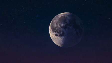 A glowing moon against a gradient night sky of deep indigo and lavender.の素材