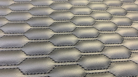 view of black leather that has been sewn using black thread with a patternの写真素材