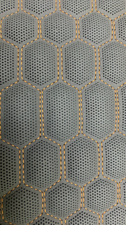 view of black leather that has been stitched and perforated with a beautiful pattern
