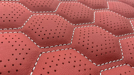 closeup the red leather texture with hole and stitchingの写真素材