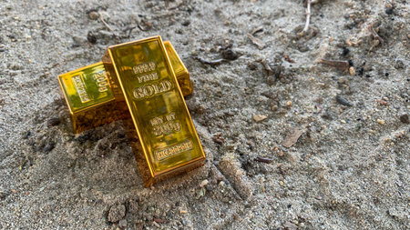 gold bars and background sandy ground, photo concept